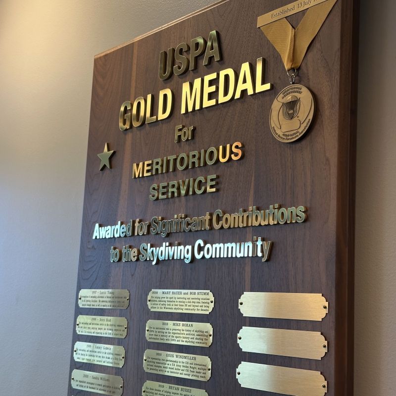 Within USPA Headquarters exists a large plaque with mounted nameplates of several recipients of the Gold Medal Award.